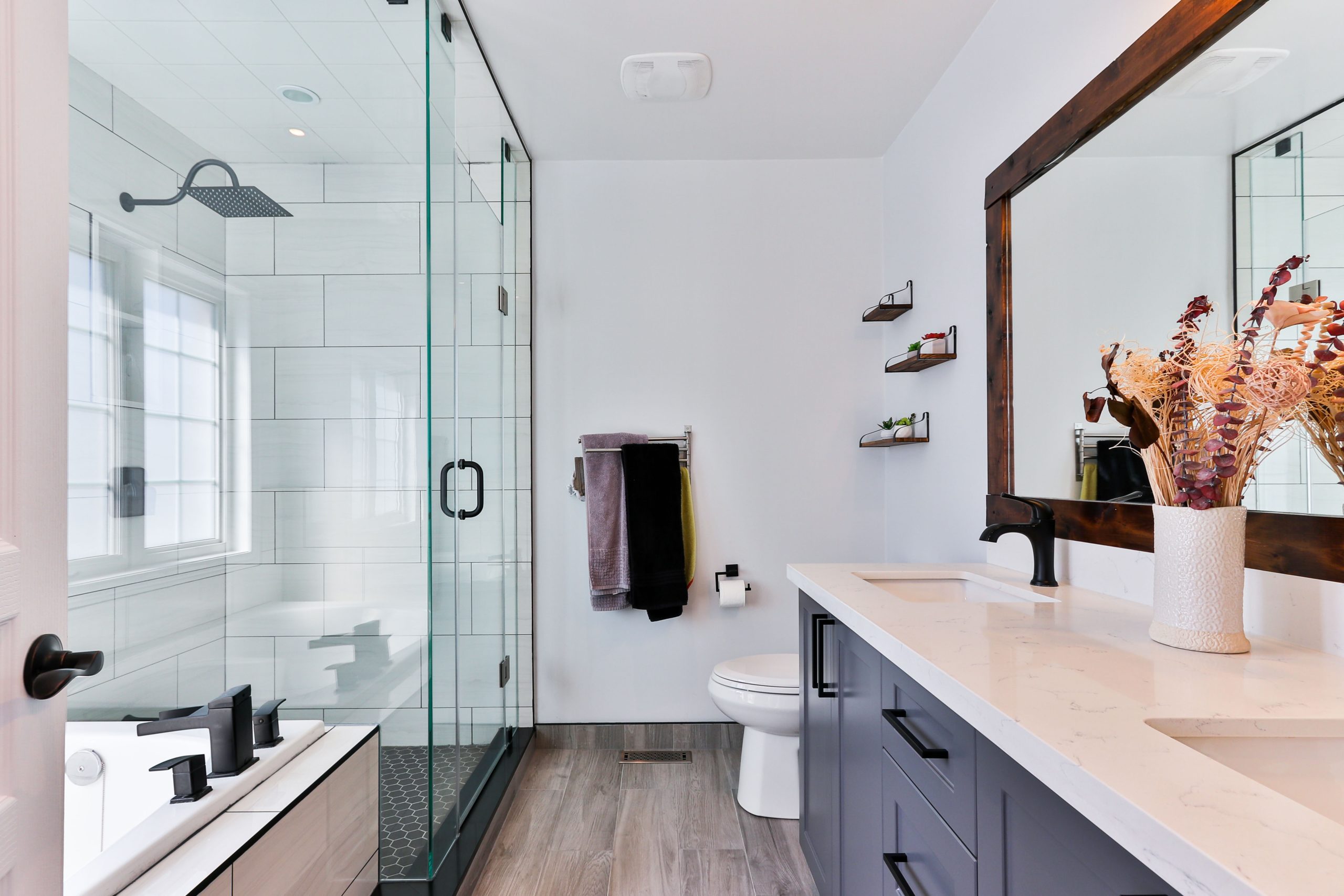 bathroom countertop with duo undermount sink and backsplash with black accessories